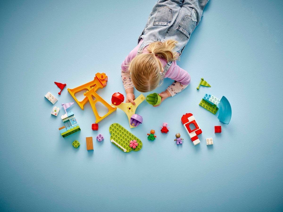 ребенок с готовой моделью LEGO радуется результату